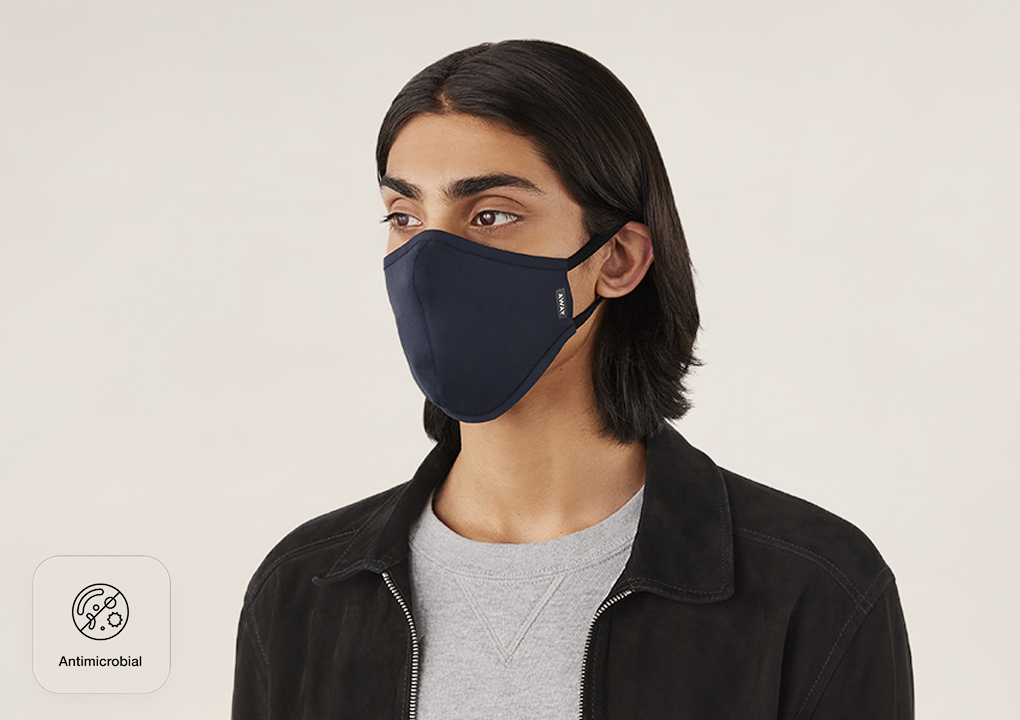 A man wearing an Away reusable cloth face mask.