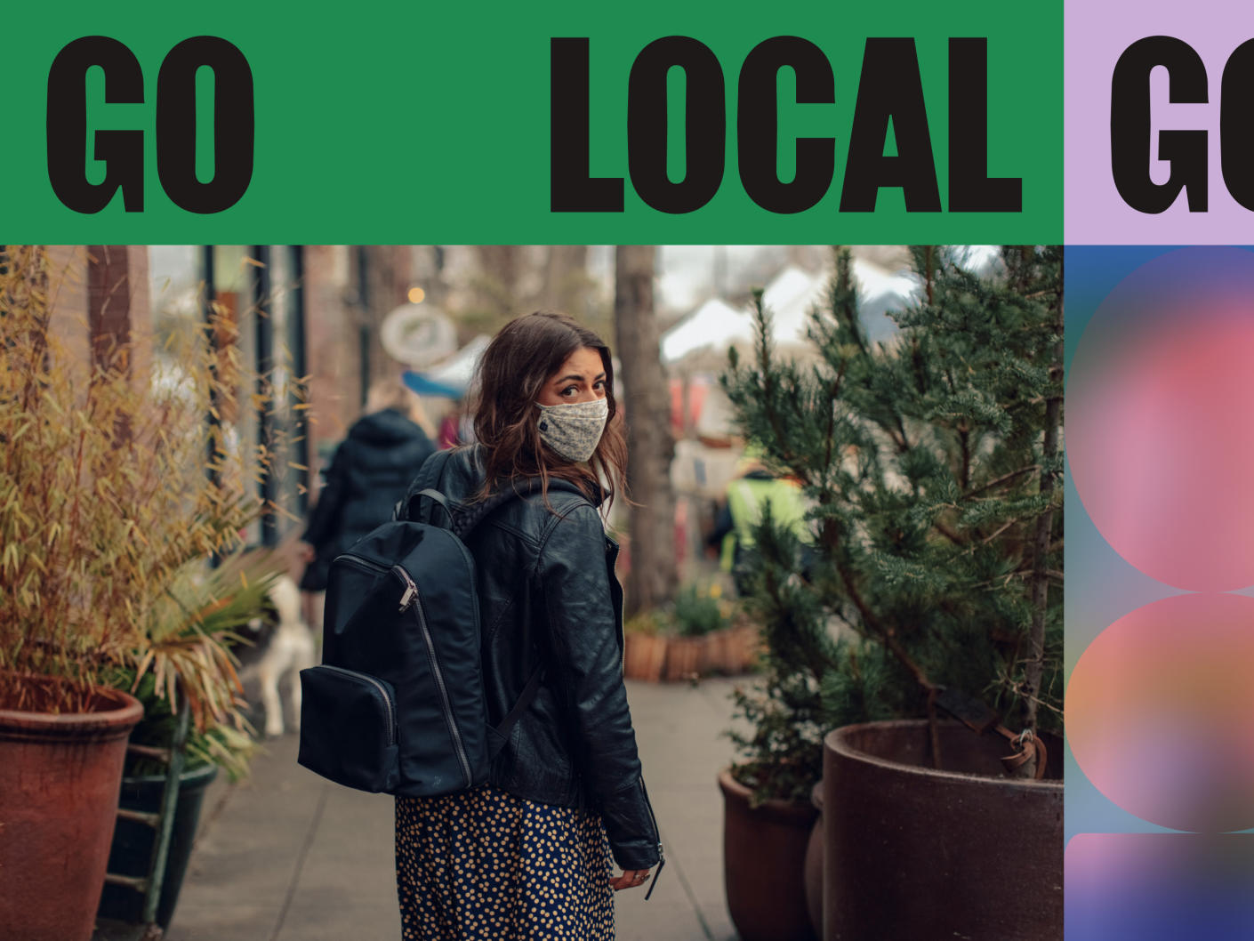 A woman with a back pack and a cloth face mask walking down a local neighborhood street with the with the label ‘Go Local’.