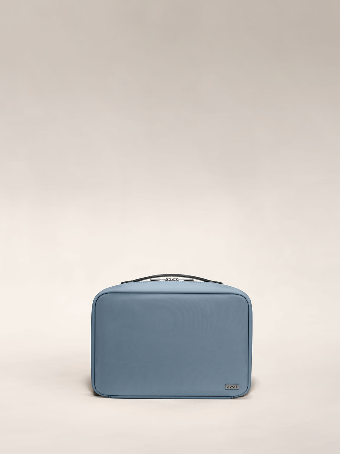 Front view of a coast blue toiletry bag with handle on top.