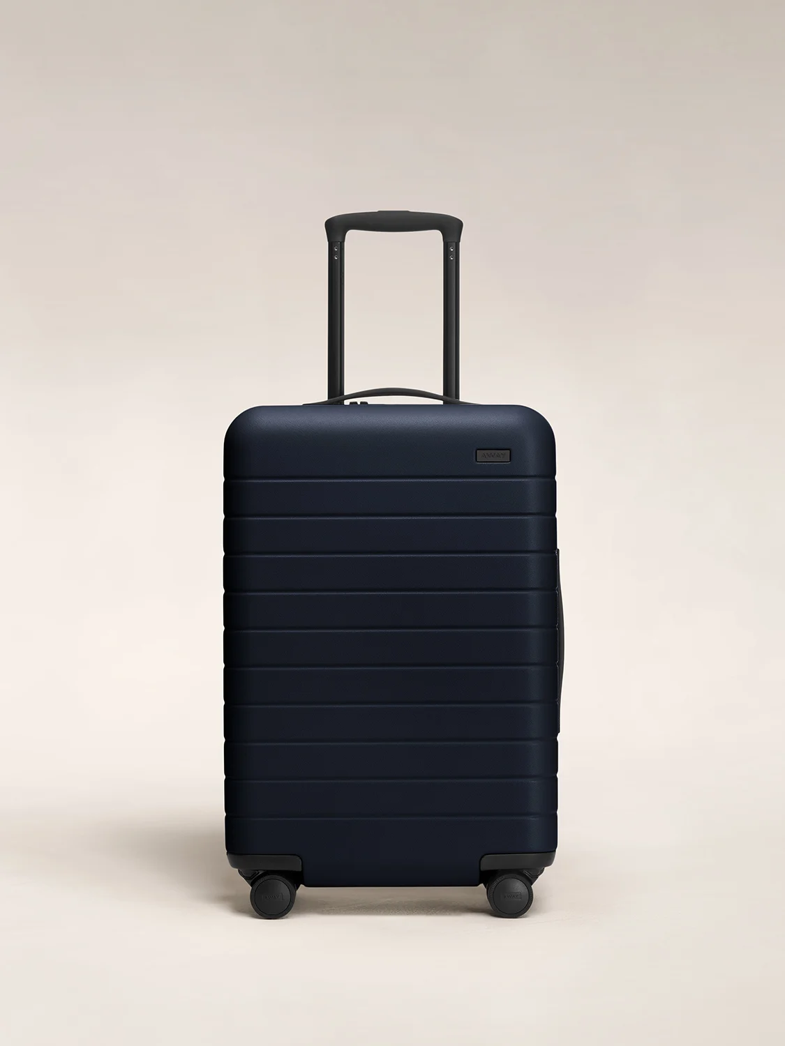 The hardside Bigger Carry-On suitcase in Navy