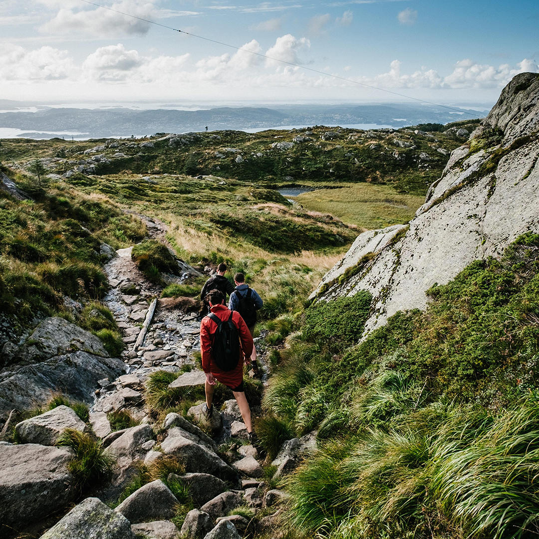Two men hiking in a mountain valley range.