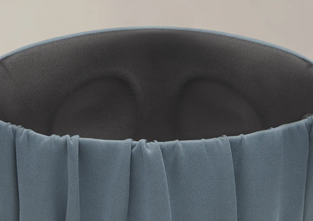 A close up of a light blue travel sleep mask showing interior contours.