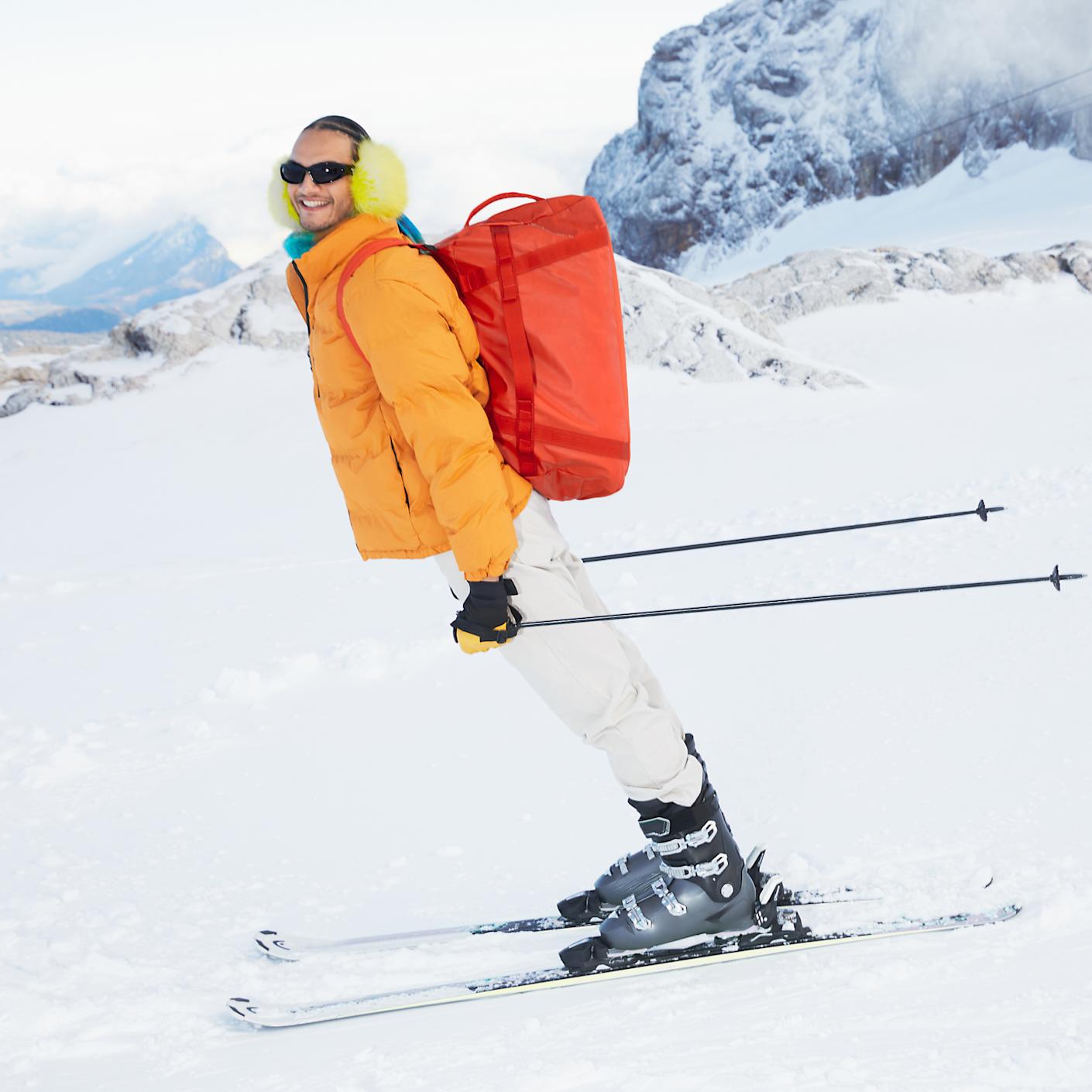 A skier carrying a F.A.R convertible backpack
