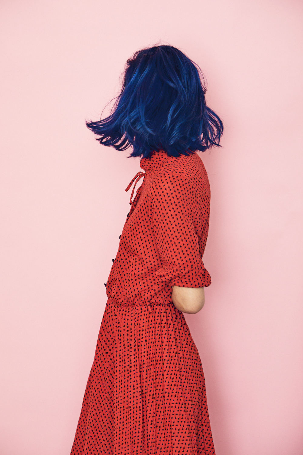 RED DRESS BLUE HAIR PINK WALL