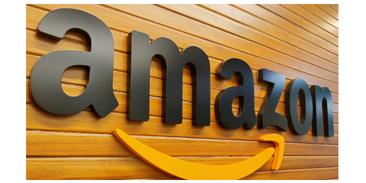 the word amazon in black letters hanging on a wooden wall with an orange arrow underneath