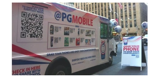 A photo of a box truck with a QR code on the side and the words “@PGMOBILE” and “Grab your phone” 
