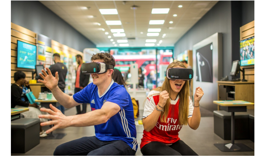 Man in blue shirt and woman in red use VR headsets