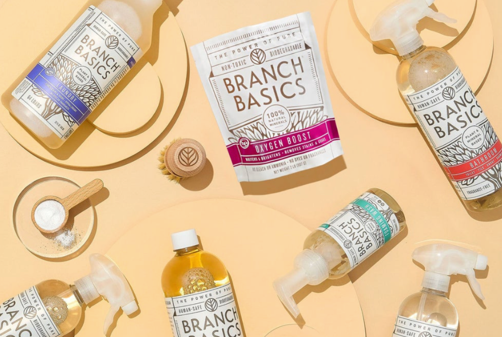 Branch Basic cleaning concentrate and refill bottles sit on a yellow backdrop. 