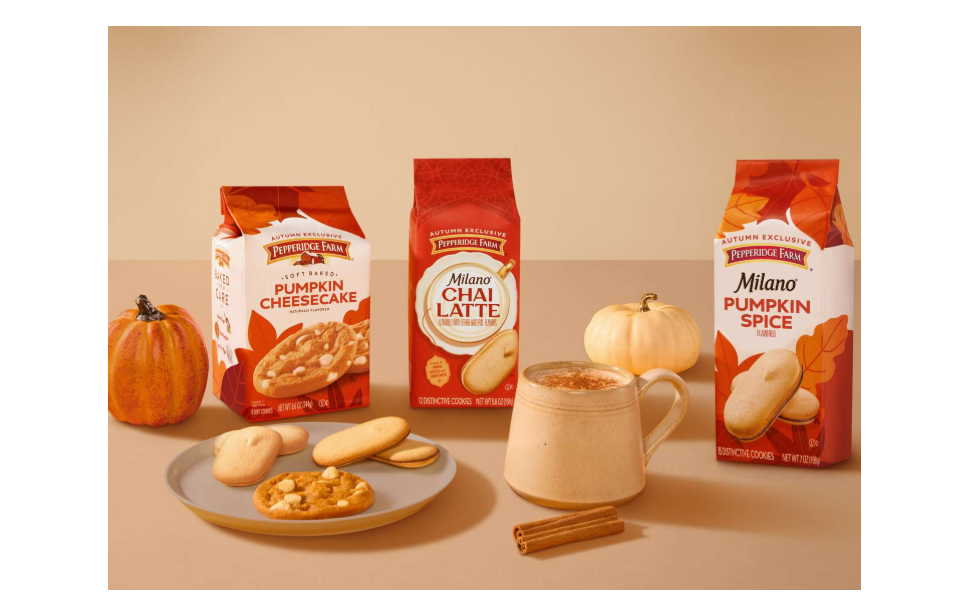 Milano chai latte cookie package alongside Milano's pumpkin flavored cookies surrounded by pumpkins and cinnamon
