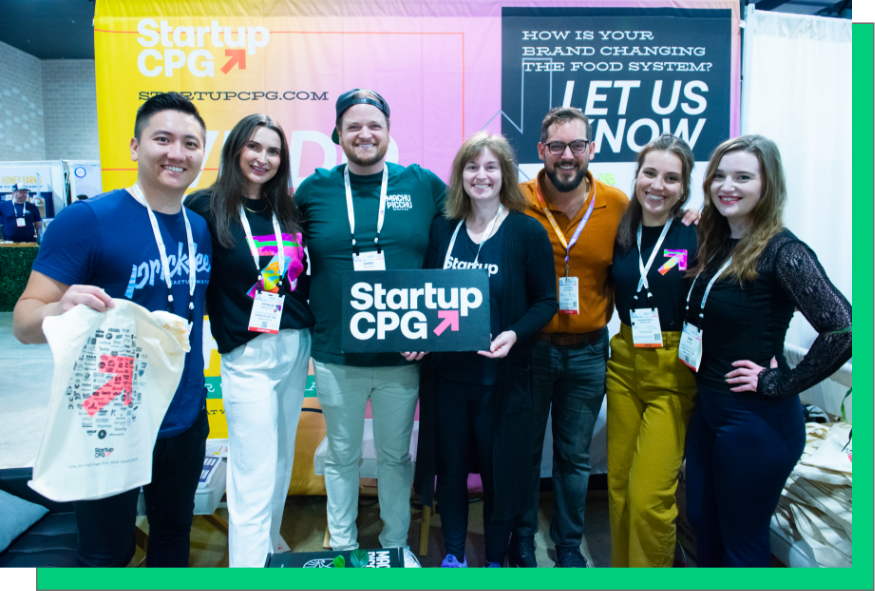 group of several Startup CPG members standing together with a sign