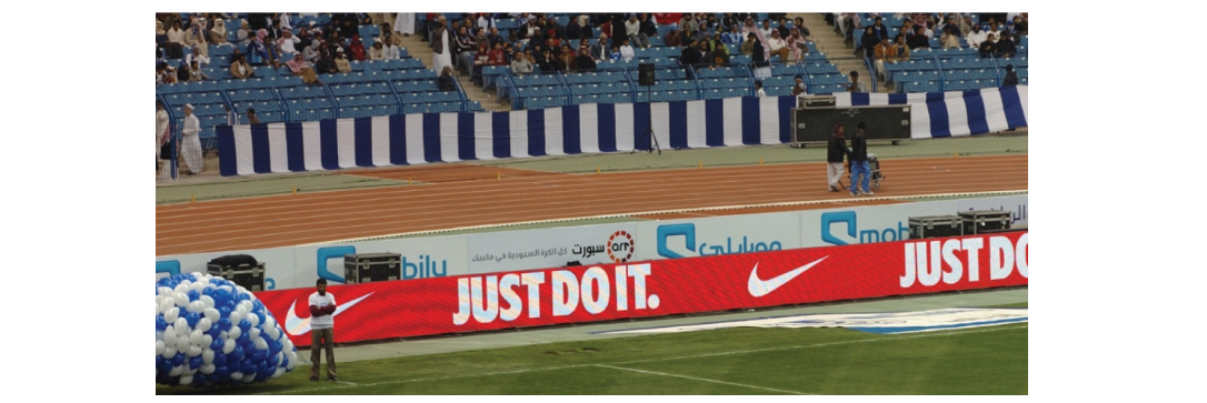 Perimeter board at football match shows Nike branding