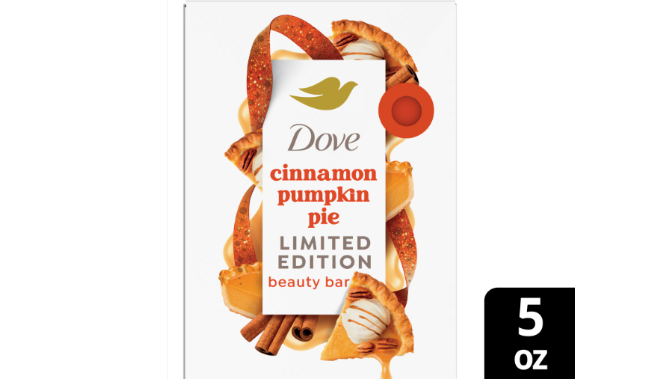 Dove soap bar package labeled ‘cinnamon pumpkin pie’ surrounded by slices of pumpkin pie, cinnamon sticks and orange streamers