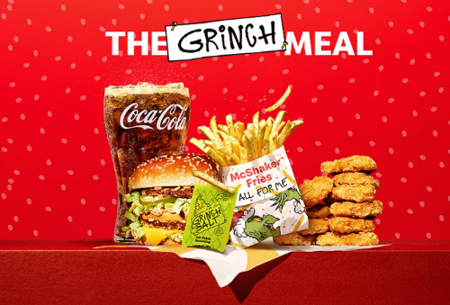 Image of McDonald's Grinch meal  burger with fries and chicken nuggets, with Grinch salt package on a red background 