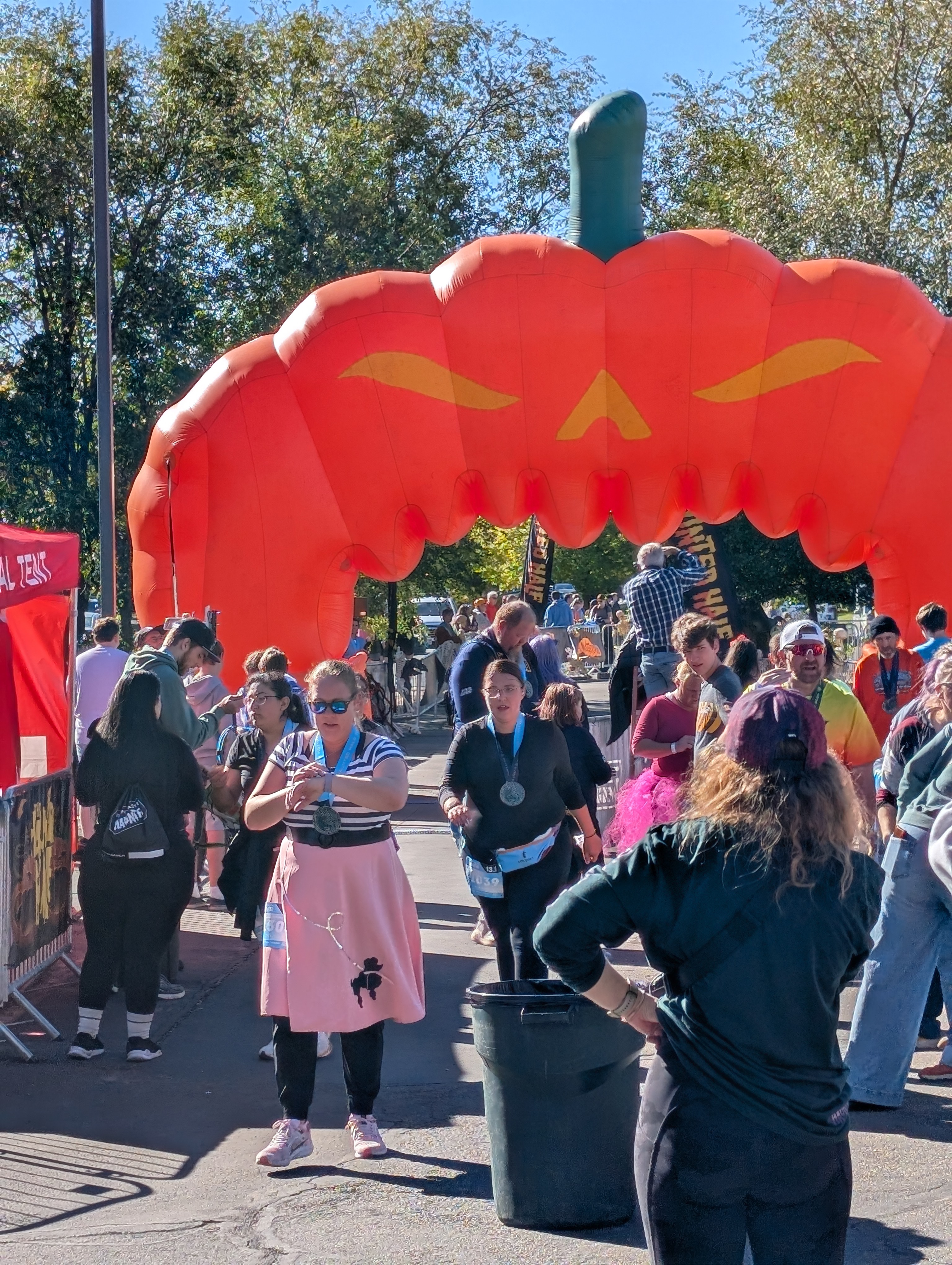 Provo Haunted Half - 13.1 - 2024 - Sara crossing the finish line