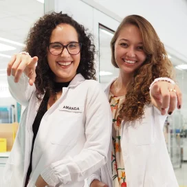 Two women pointing at the camera