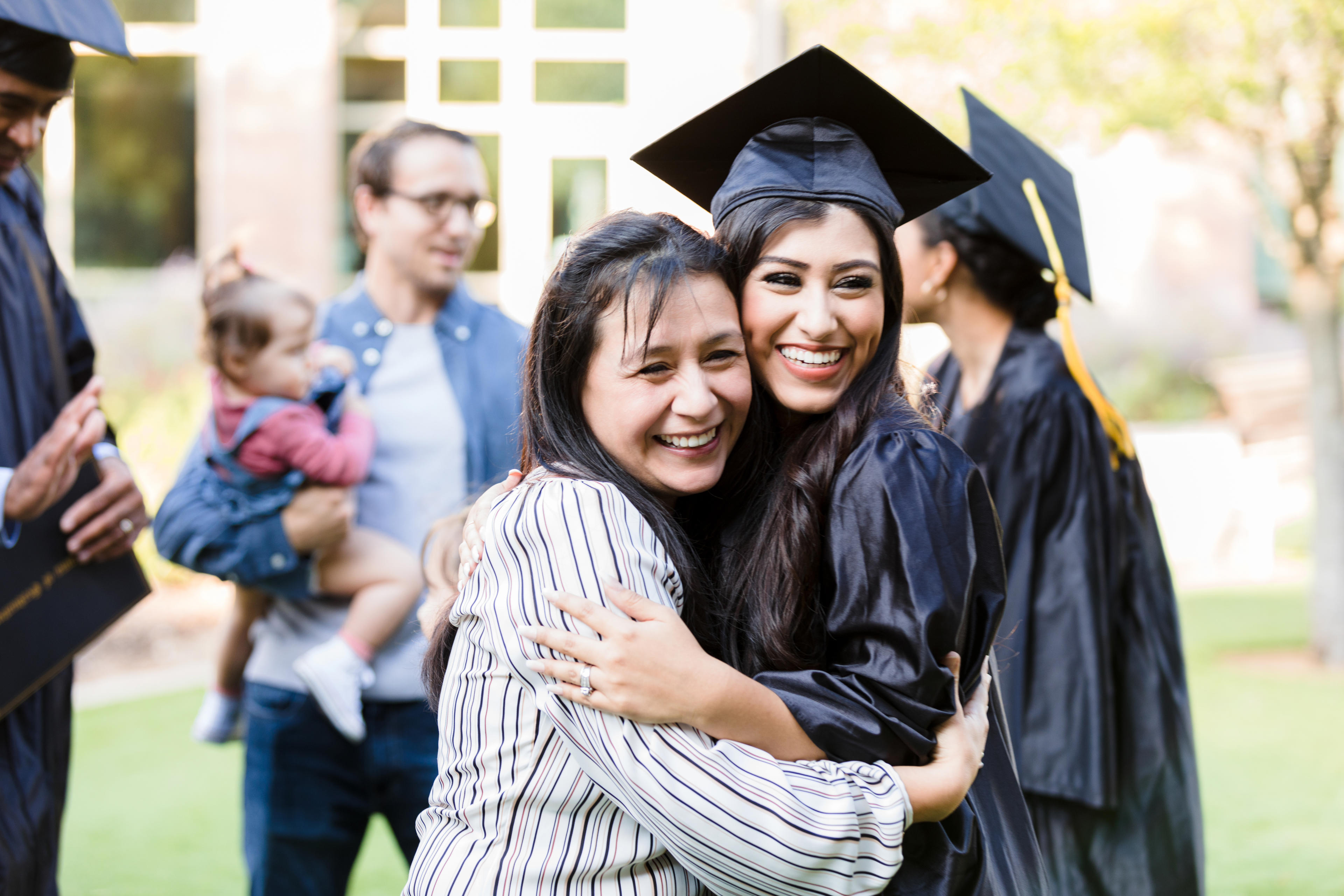 College graduate hugging mom