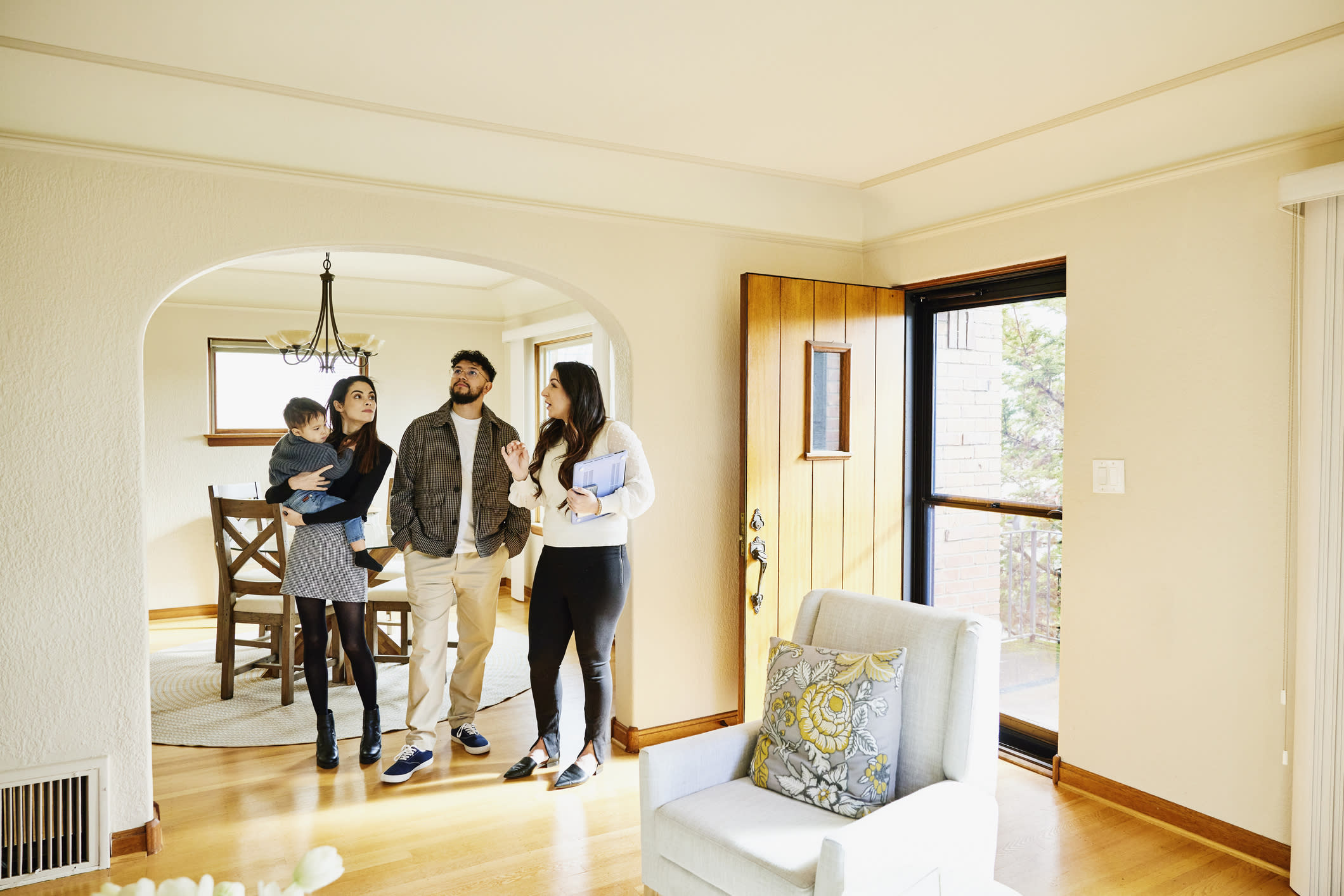 a group of people standing in a living room