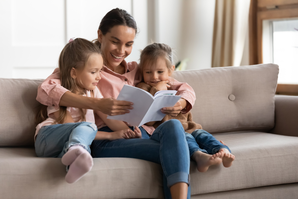Caregiver and young children reading