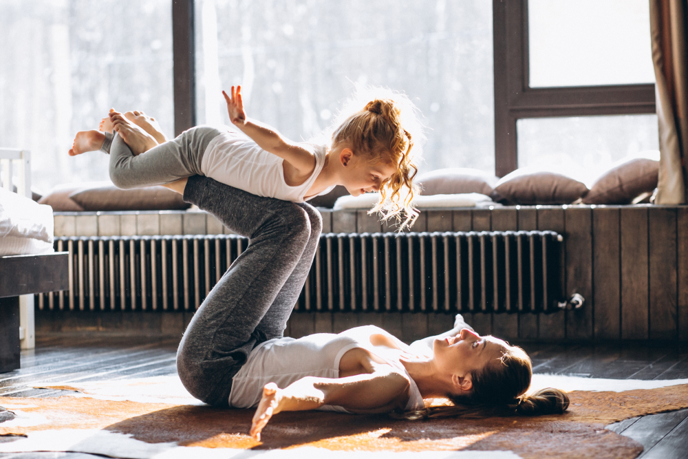 caregiver and child stretching their bodies 