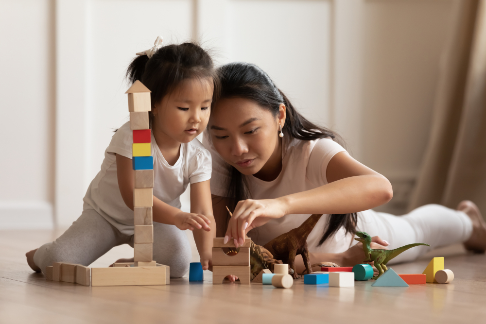 Caregiver and child playing with blocks. 