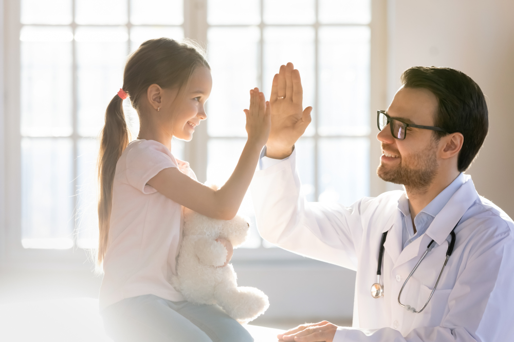 Child and physician high five