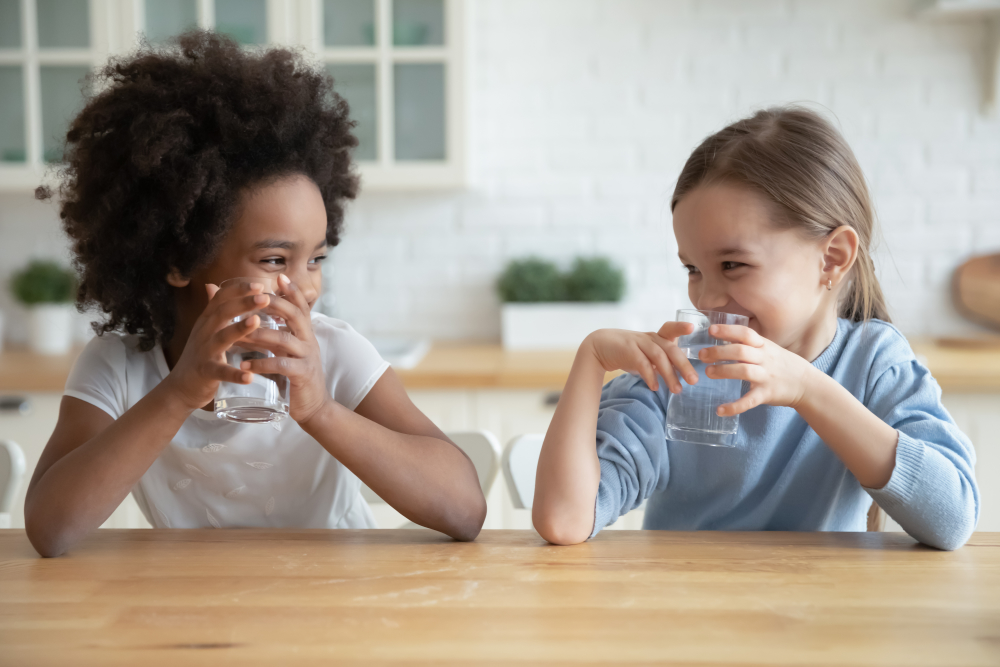 Two kids drinking water