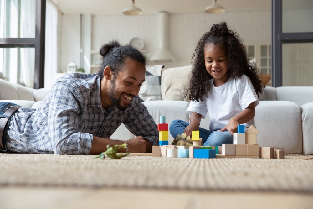 Caregiver and child playing with building blocks 