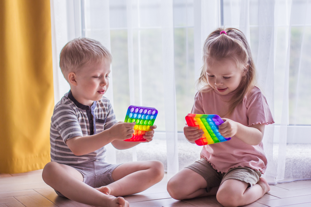 Two children playing with visual stims 