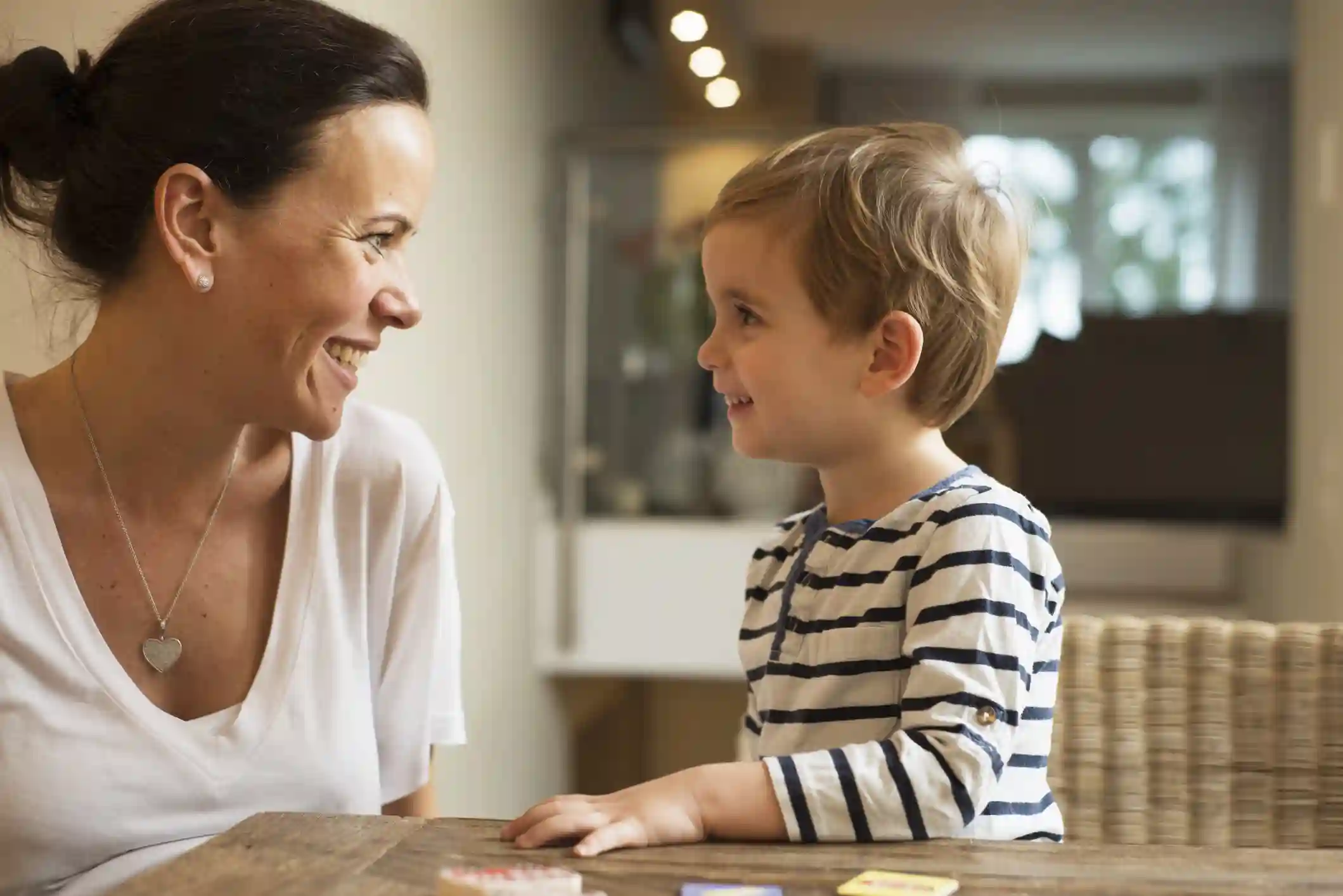 A woman and child look at each other and smile