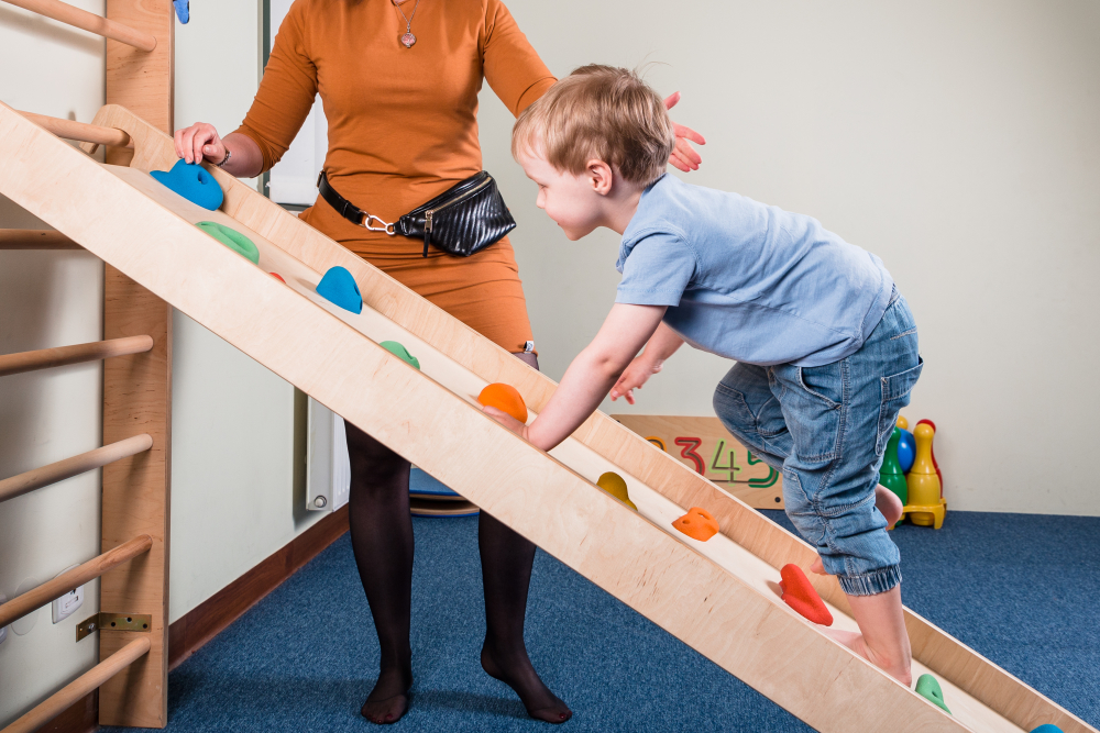 Young child climbing during a physical therapy session