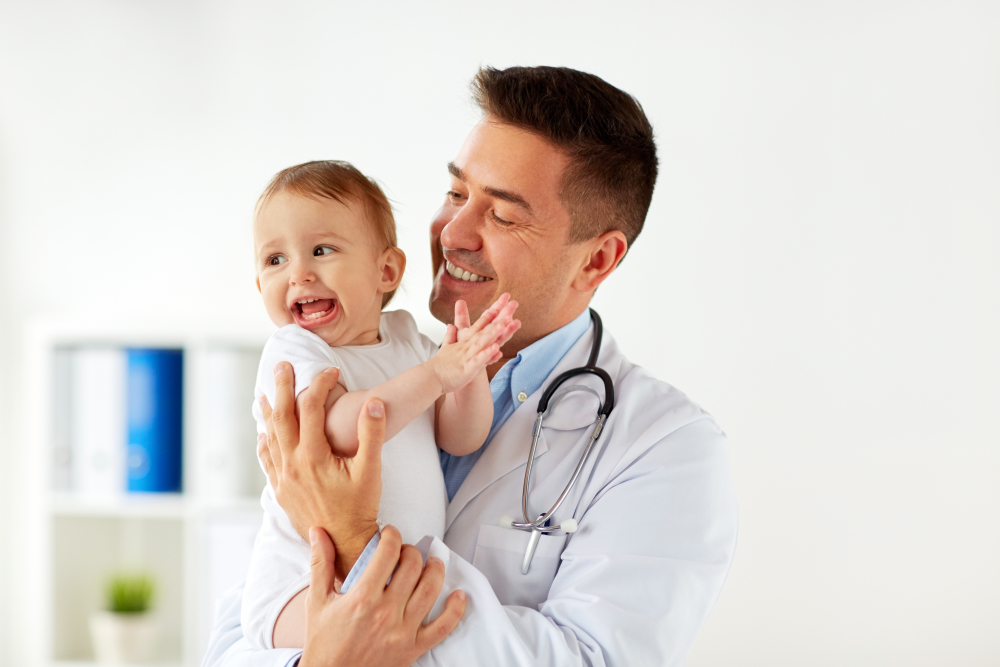 Doctor holding young child 