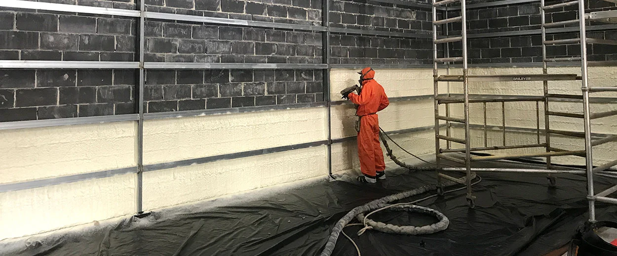spraying insulation in warehouse 