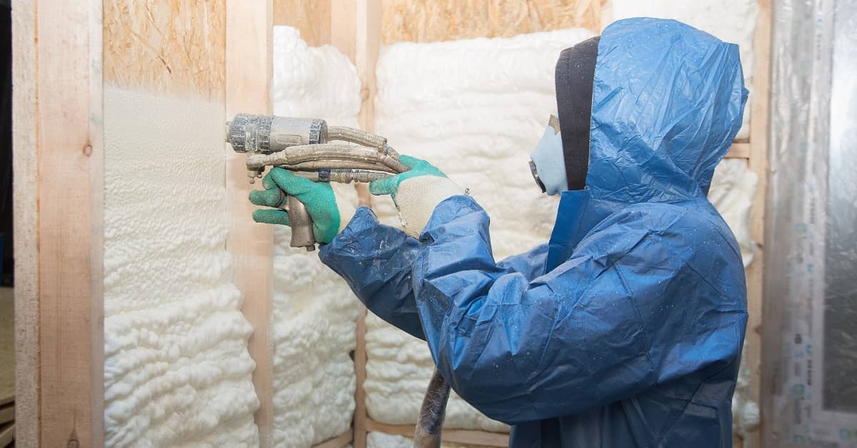 person spraying foam insulation