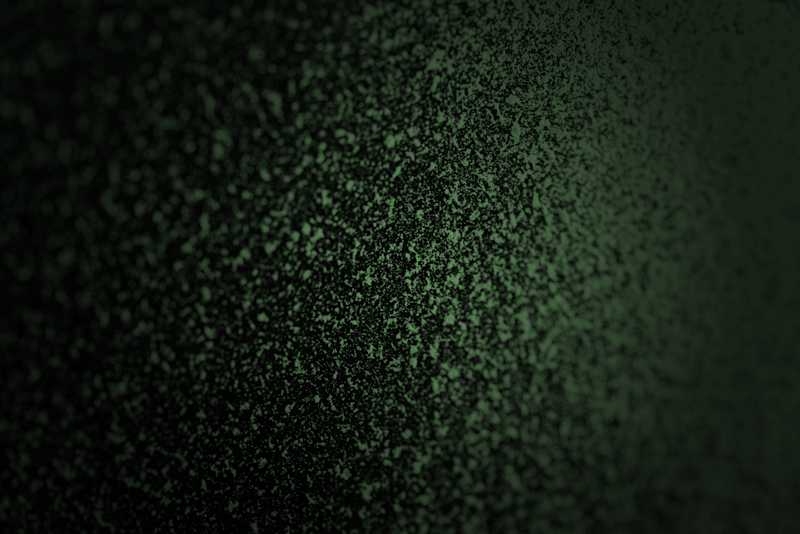 Green particles on dark background