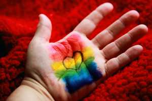 pride month flag painted on hand