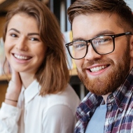 Glücklich lächelnde Studierende in der Bibliothek