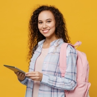 Studentin mit Tablet grinst in die Kamera