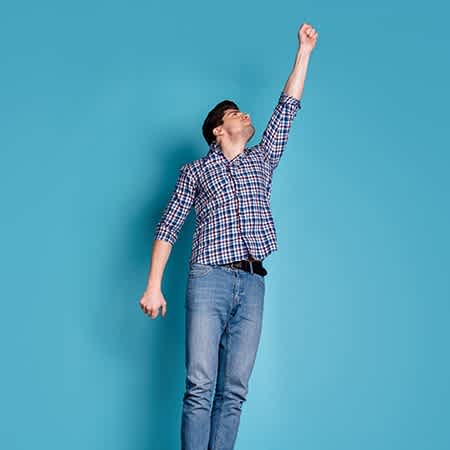 Studierender macht Superman Pose als würde er fliegen
