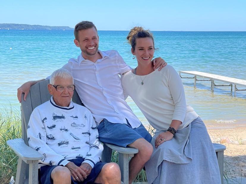 Leelanau County Commissioner candidate Scott Perry pictured with his wife, Hannah, and his grandpa, Robert, near East Grand Traverse Bay in Elk Rapids