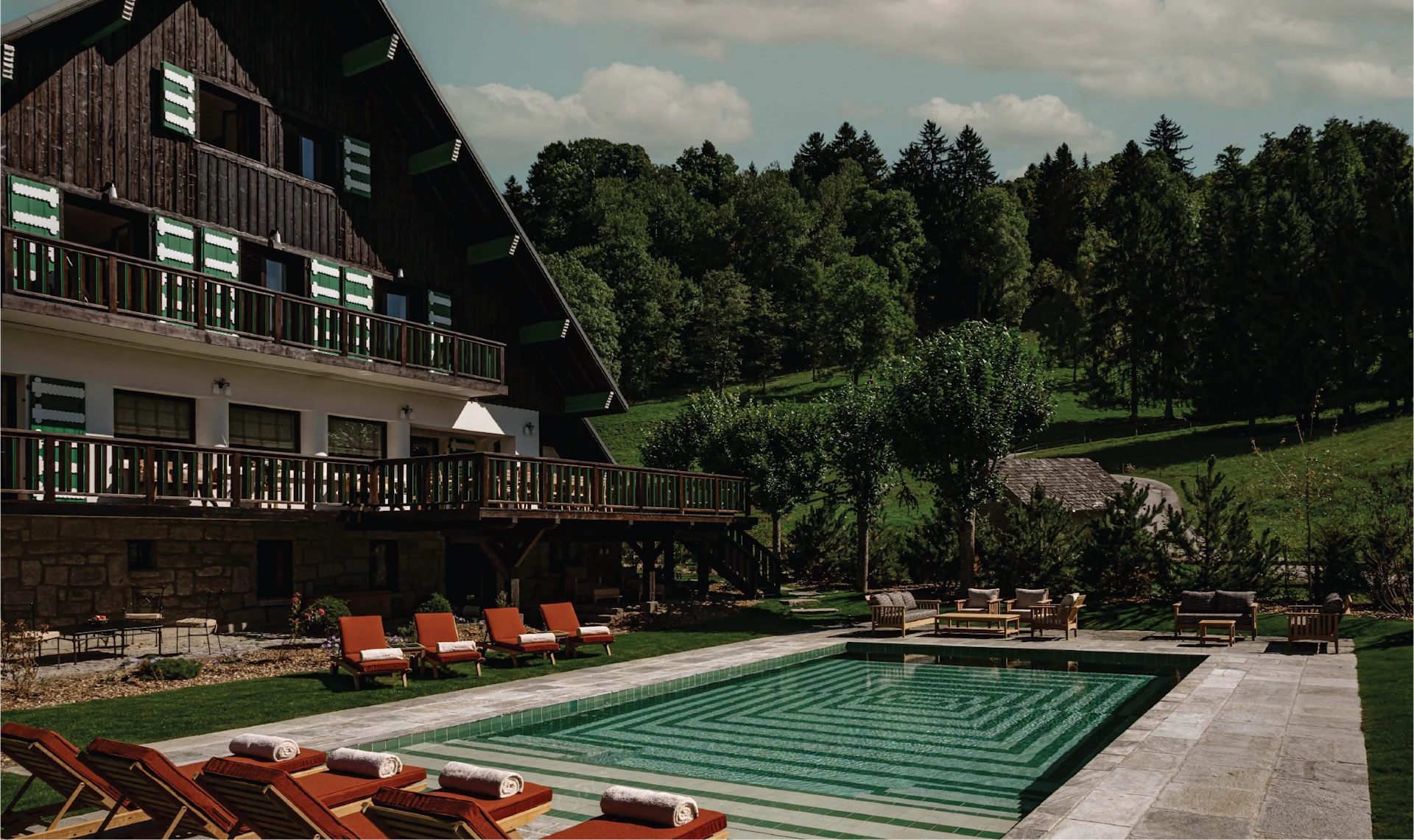 Art Deco alpine chalet in Megève designed by Henry Jacques Le Même, with sculpted wood interiors, mountain views, heated pool, and spa blending heritage architecture with modern comfort.