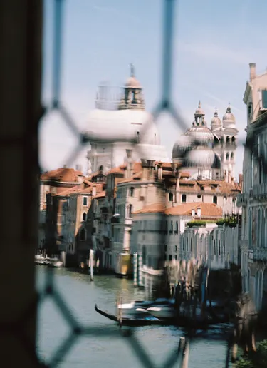 Buildings through chain link fence 