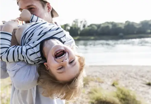 Father with child in arms outdoors