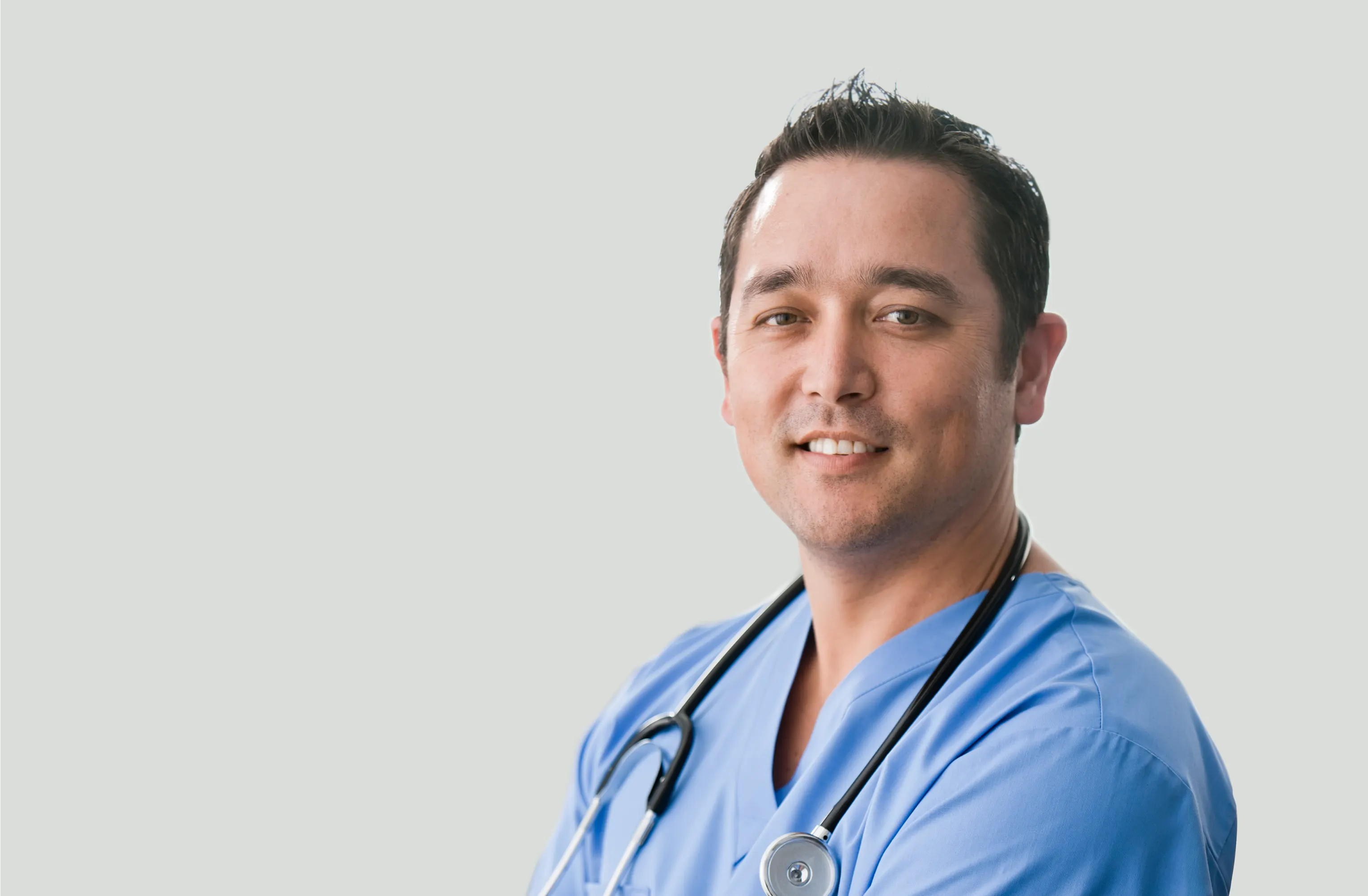 Middle aged white male in blue doctor scrubs