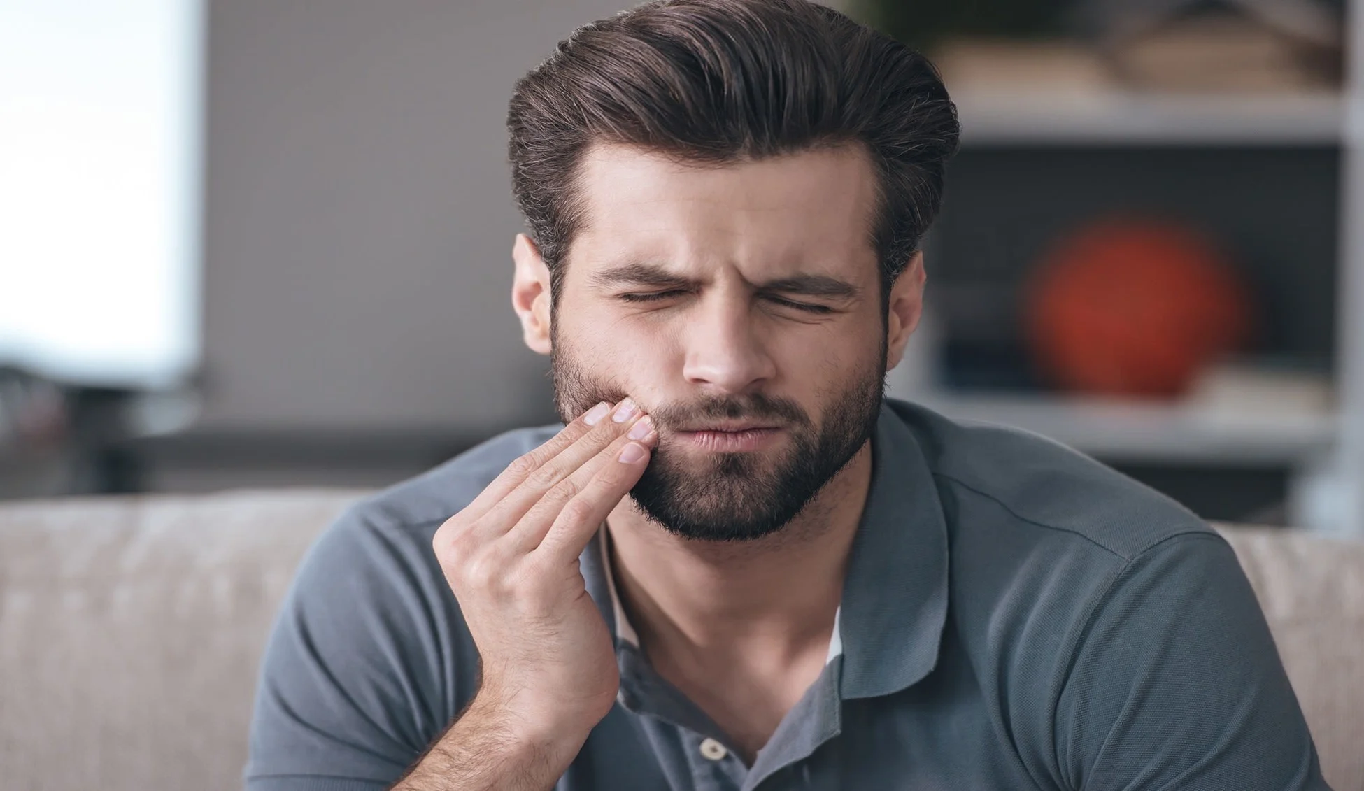 man in pain due to swollen gum around one tooth article banner