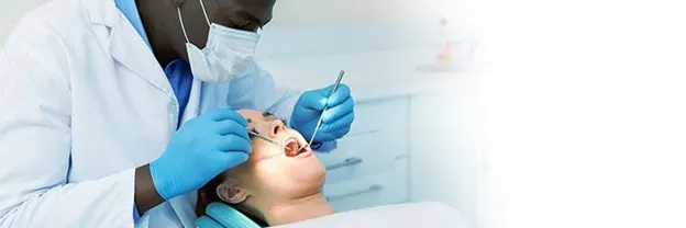Doctor performing tooth extraction procedure on woman article banner
