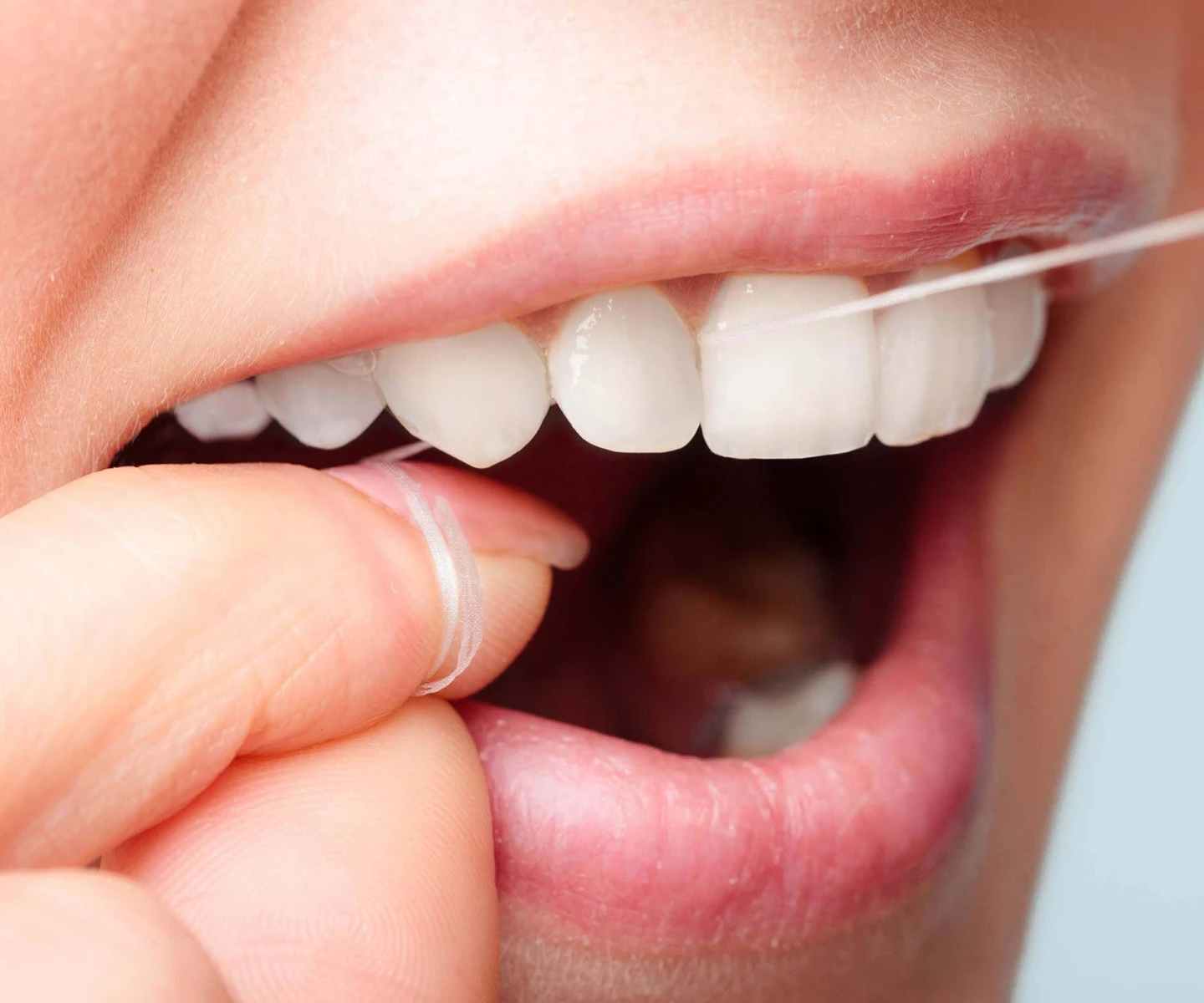 A person using an Oral-B floss