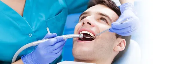 Dentist cleaning his teeth to prevent tooth decay article banner