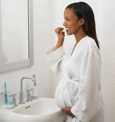 Pregnant woman brushing her teeth article banner
