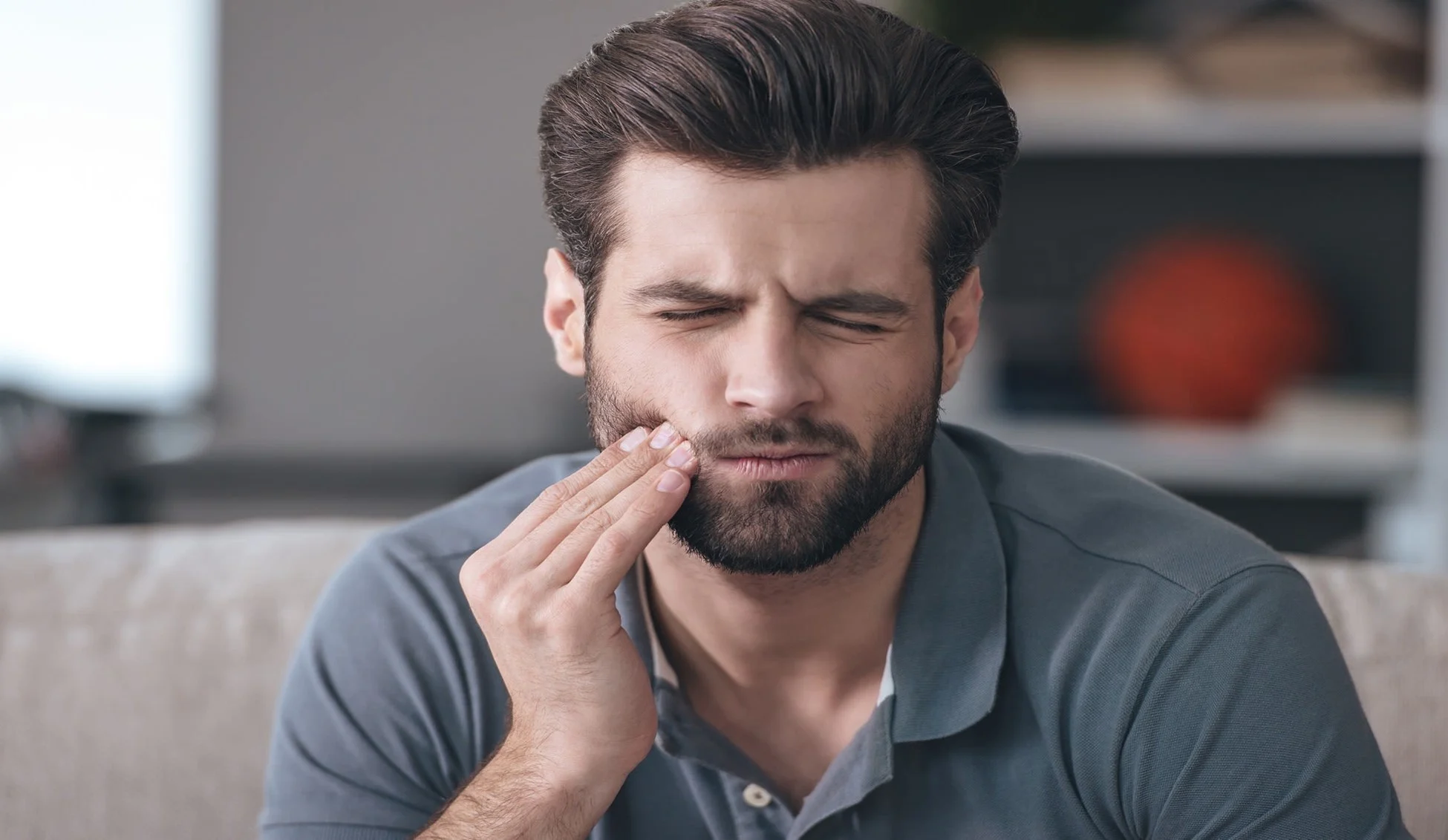 man suffering from tooth pain due to bruxism article banner