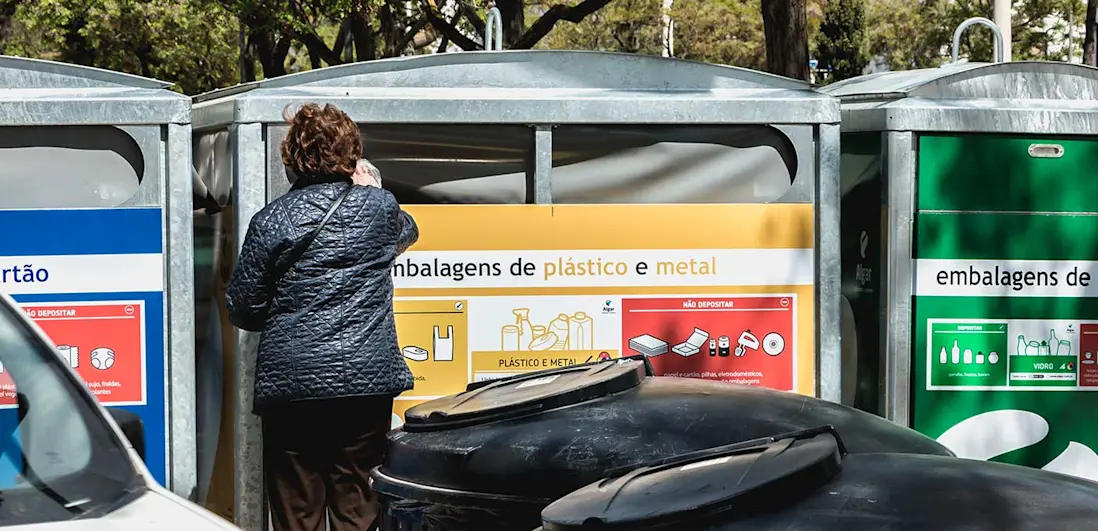 Mulher a colocar plástico no ecoponto